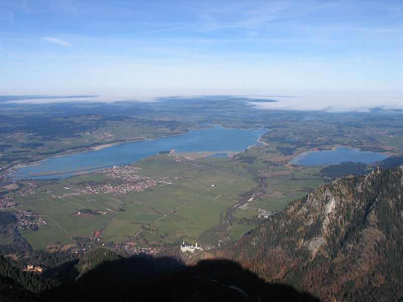 Windsurfen und Kitesurfen am Forggensee - mit Neuschwanstein im Vordergrund und der Landzunge am Campingplatz Brunnen im Hintergrund